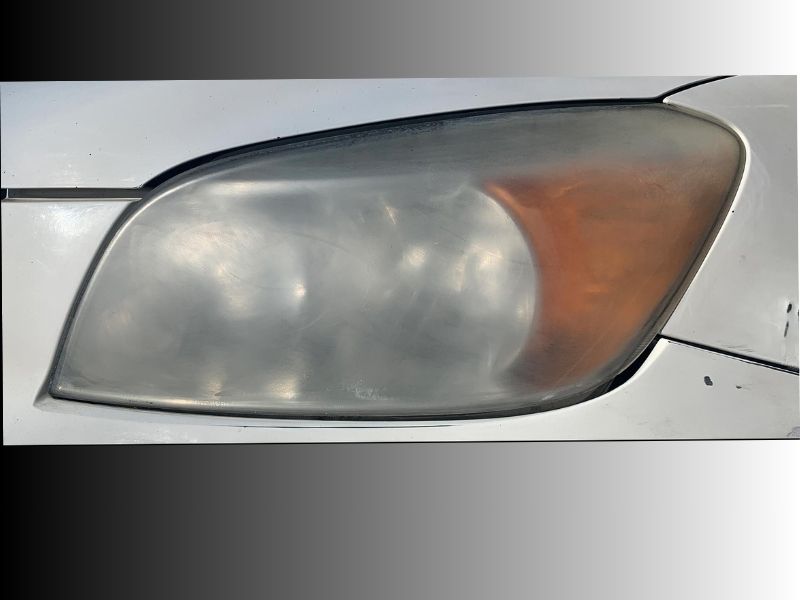 Before headlight restoration showing cloudy oxidized headlight